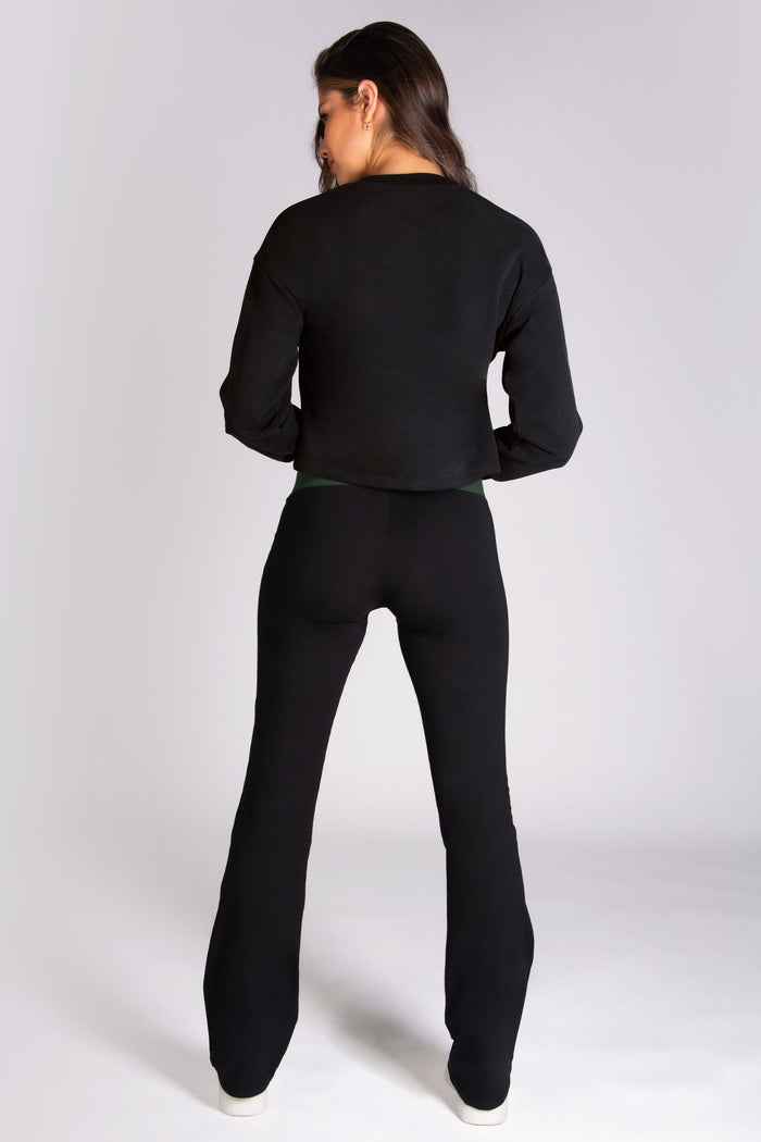 Women's black dance flares worn with black crop boxy sweater