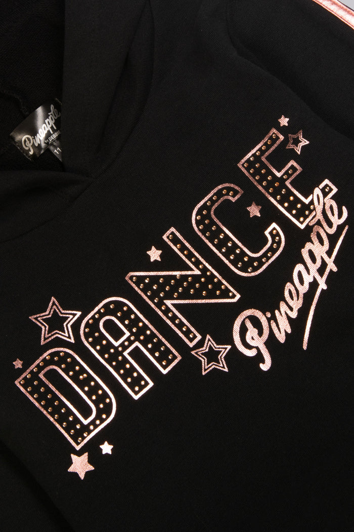 Detail shot of chest print of black hoodie featuring diamantΓ©s, stars, and Pineapple Dance Studios logo