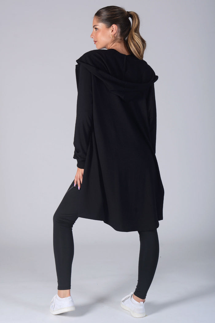 Woman wearing black Longline Hooded Zip Jacket and black pocket leggings