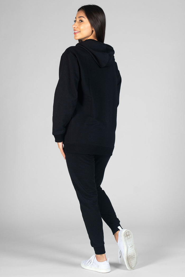 Woman wearing black Loopback Joggers and black hooded jacket