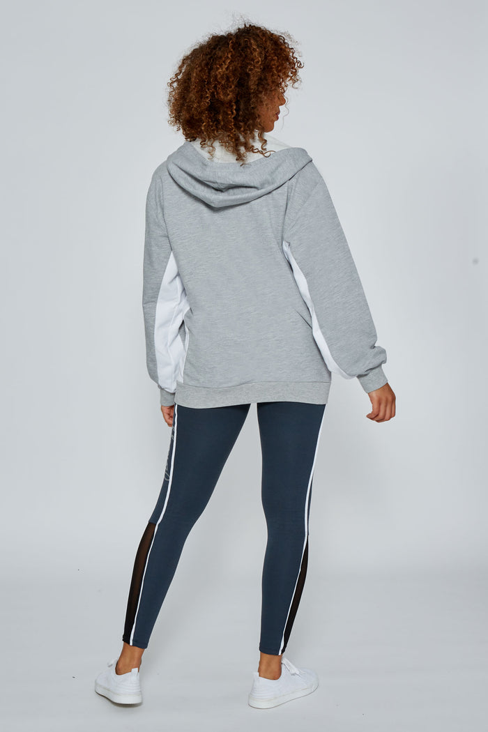 Woman wearing Grey Marl Stripe Zip Hoodie and charcoal Leggings with white piping