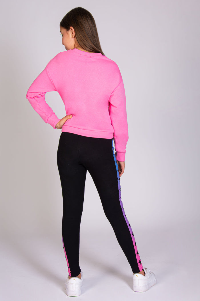Baggy and oversized pink jumper for girls paired with The Next Step black leggings.