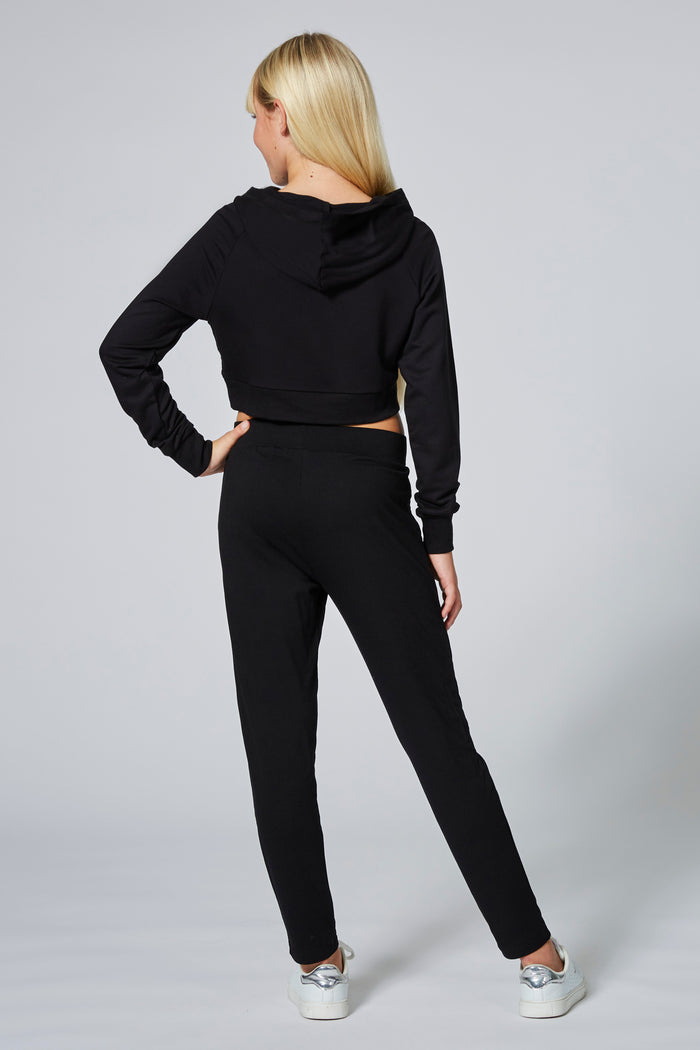 Girl wearing Black Viscose Trousers and cropped black hoodie with print logos