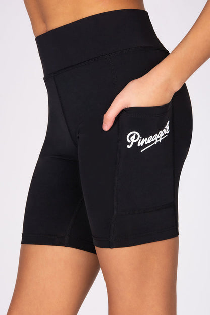 Black shorts with a visible brand logo on a white background