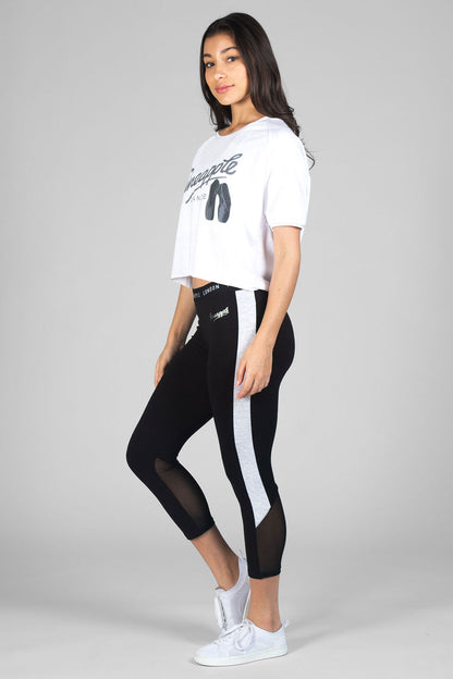 Woman wearing white Ballet Slouchy T-Shirt and black Jacquard Crop Leggings with white panels