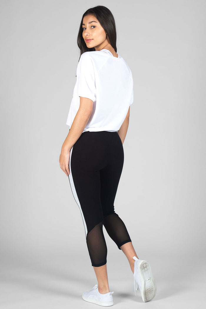 Woman wearing cropped white Ballet Slouchy T-Shirt and black Jacquard Crop Leggings