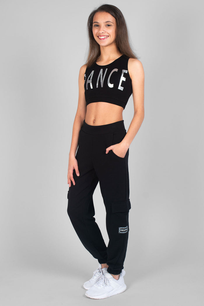 Girl wearing black Cargo Joggers and black Crop Dance logo Vest