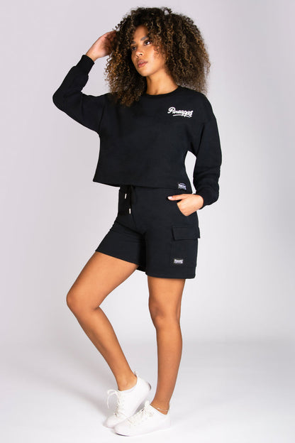 Black cargo shorts modelled by Alyce Justyne wearing a Pineapple sweat top