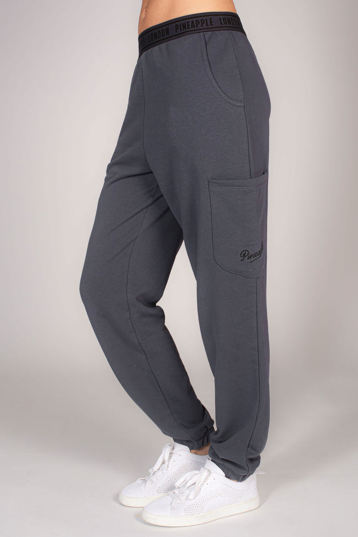 Women's grey combat joggers with multiple pockets and branded waistband.