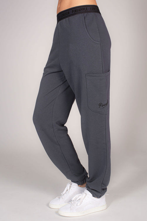 Women's grey combat joggers with multiple pockets and branded waistband.