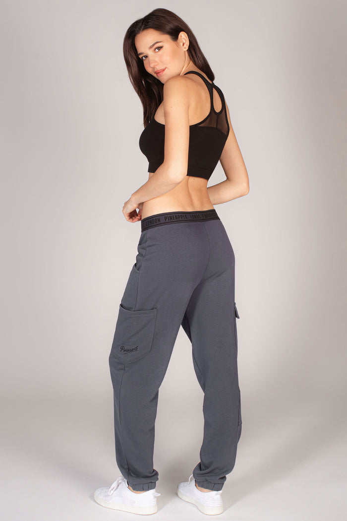 Dark grey combat joggers with large pockets worn with black crop top by Debbie Moore.