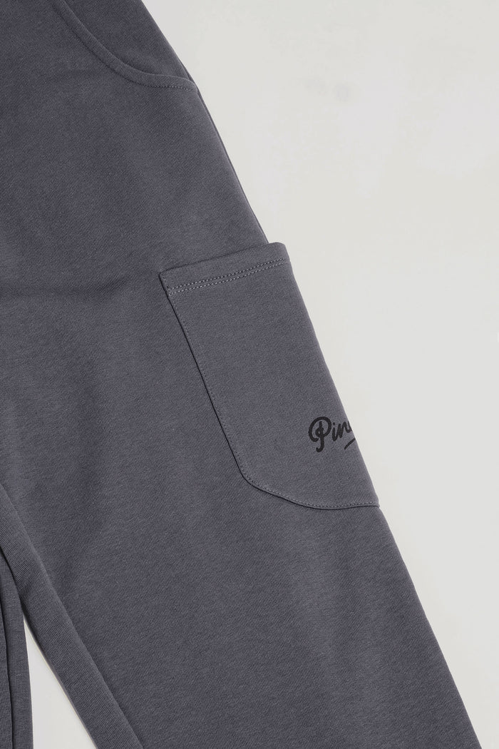Detail of pockets on grey combat joggers for women.