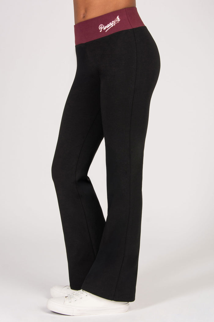 Black flared pants with a maroon waistband featuring a logo on a white background
