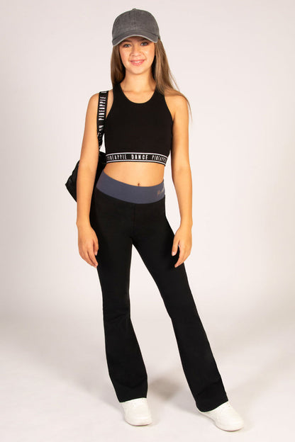 Teen's flared leggings in black with wide elasticated waistband in dark grey colour and small silver foil Pineapple Dance Studios branding.
