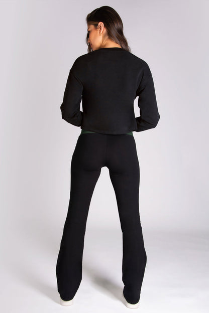 Women's black dance flares worn with black crop boxy sweater