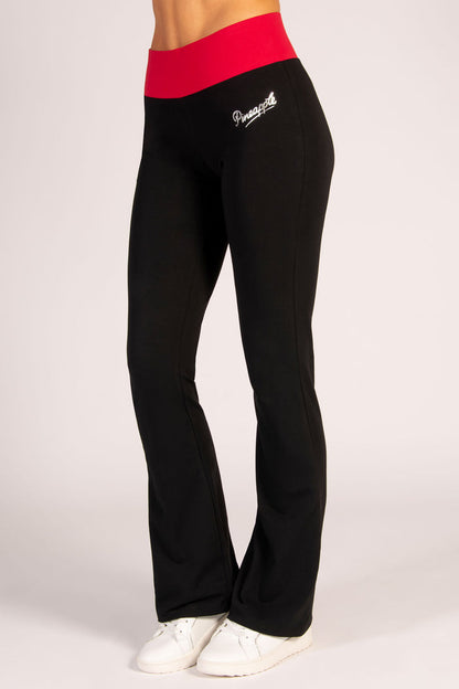 Women's black flared trousers with red elasticated waistband.