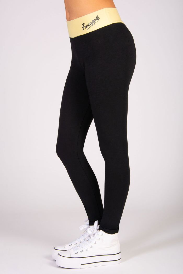 Black cotton-rich stretchy leggings with butter yellow waistband.