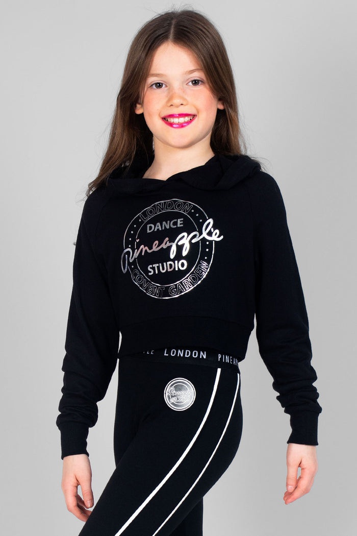 Girl wearing black Crop Hoodie with silver logos