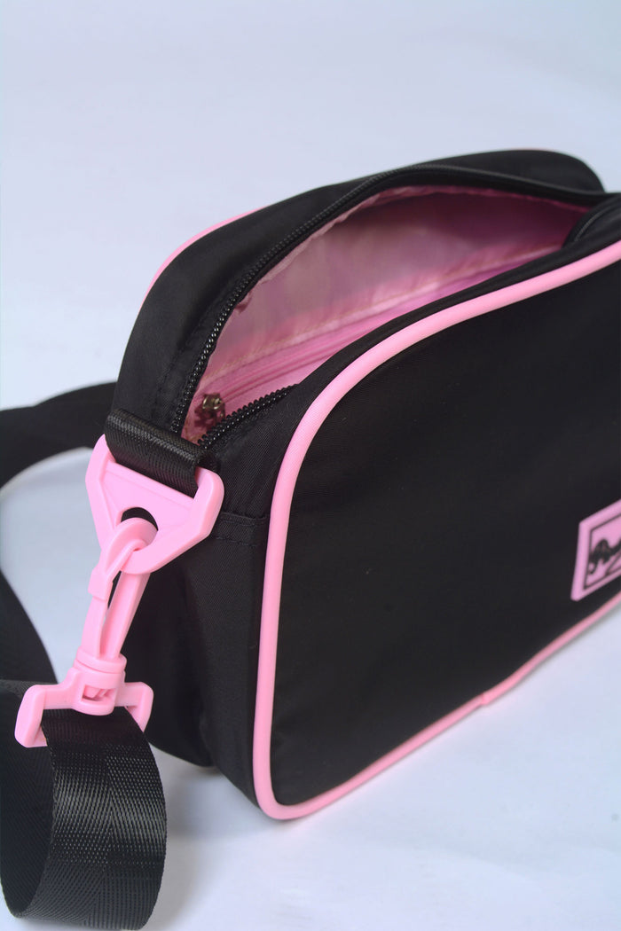 Pink lined interior of black Crossbody Bag for kids