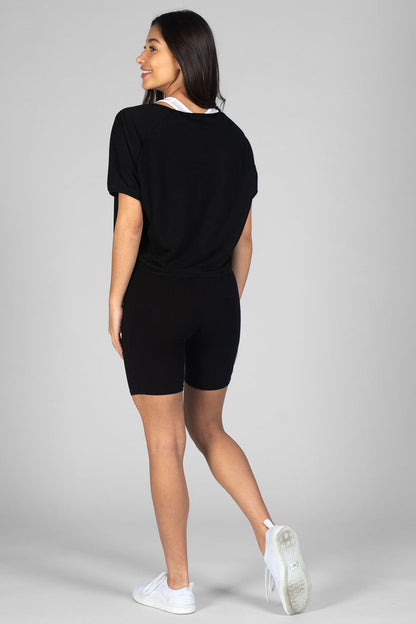 Woman wearing black Cycling Shorts and black cropped loose-fit T-Shirt