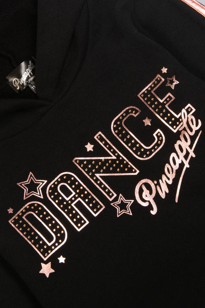 Detail shot of chest print of black hoodie featuring diamantés, stars, and Pineapple Dance Studios logo