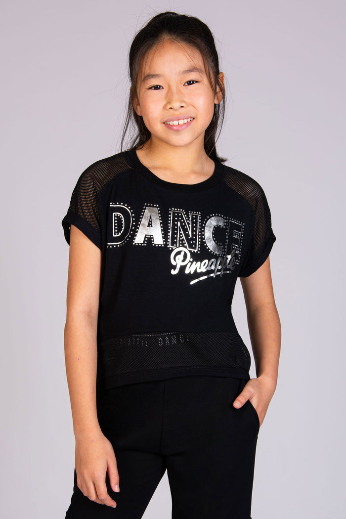 Girl wearing black dance t-shirt in a. cropped fit with Dance print and diamantés across the chest.