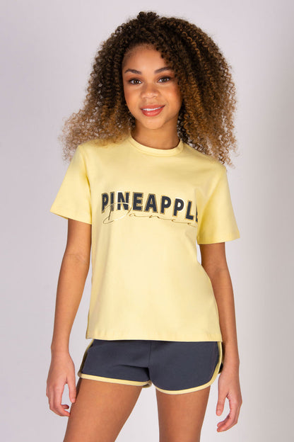 Skylar Blu wearing butter yellow dance t-shirt with dark grey sporty shorts.
