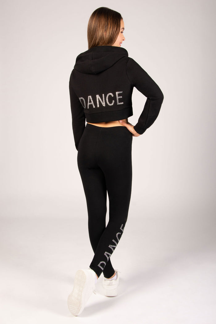 Person wearing a black 'DANCE' hoodie and leggings on a white background