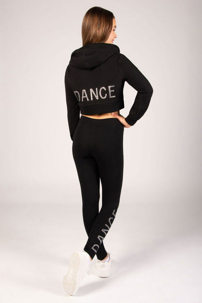 Person wearing a black 'DANCE' hoodie and leggings on a white background