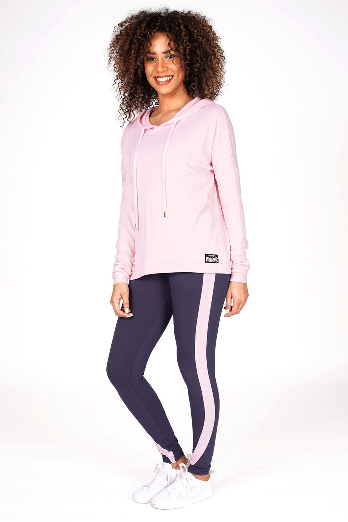 Woman wearing Pink Dip Hem Hoodie and charcoal racer stripe leggings