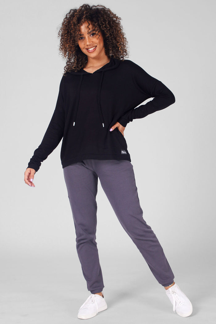 Woman wearing Black Dip Hem Hoodie and charcoal track pants