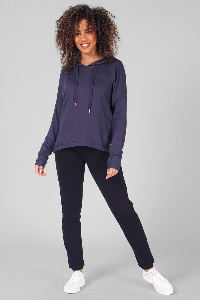 Woman wearing Charcoal Dip Hem Hoodie and black track pants