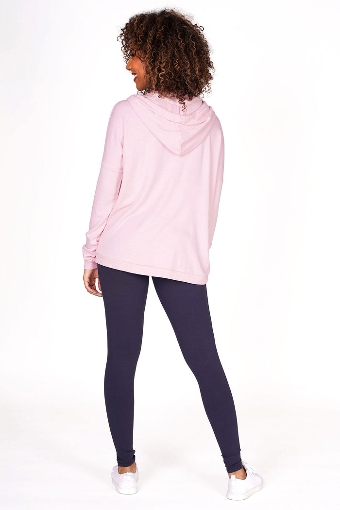Woman wearing Pink Dip Hem Hoodie and charcoal racer stripe leggings, back view