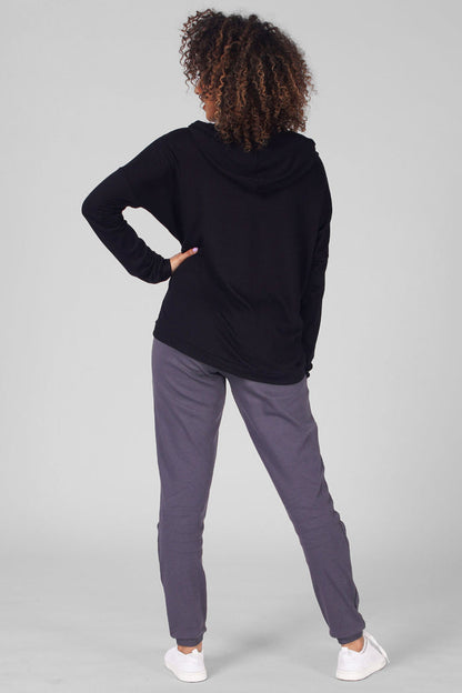 Woman wearing Black Dip Hem Hoodie and charcoal trousers