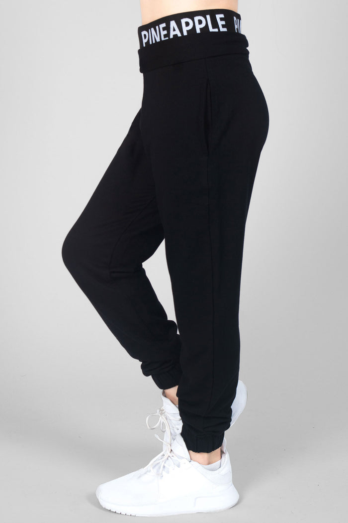 Summer Rose wearing girls' black joggers with double Pineapple band