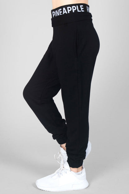 Summer Rose wearing girls' black joggers with double Pineapple band