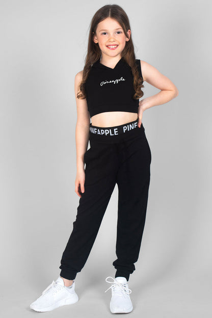 Girl wearing pineapple dance joggers and pineapple crop top in black