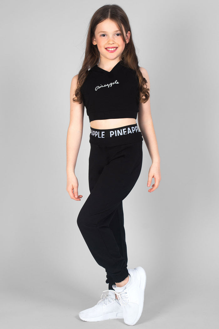 Summer Rose wearing girls' black joggers with double Pineapple band