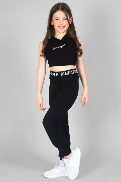 Summer Rose wearing girls' black joggers with double Pineapple band