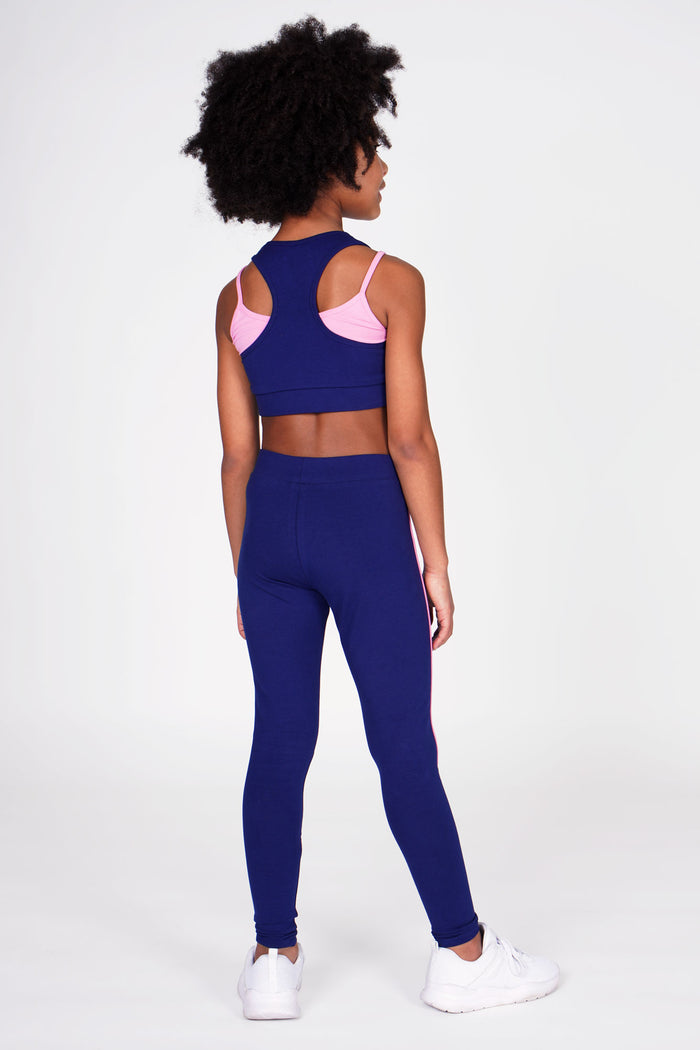 Girl wearing Pineapple navy double layer bra and navy piping leggings