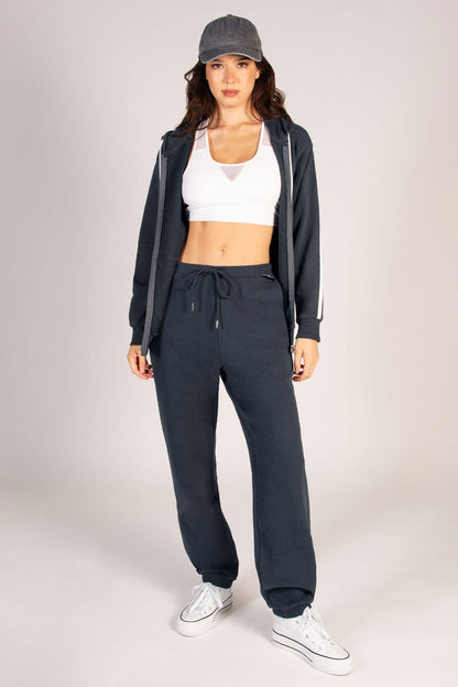 Women's oversized dark grey joggers with pockets and drawstring waistband.
