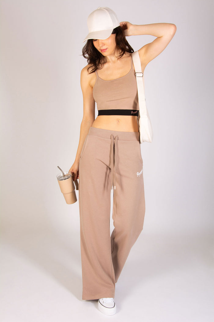 Women's mocha athleisure outfit featuring essential wide leg joggers and midi crop top