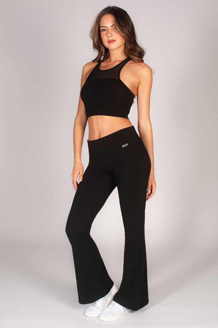 Women's black flare jersey trousers by Pineapple Dance Studios worn by Kiann Louise.