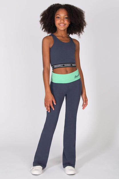 Girl wearing a dark grey flared jersey trousers with mint green fold-over waistband with matching tank top on a light grey background