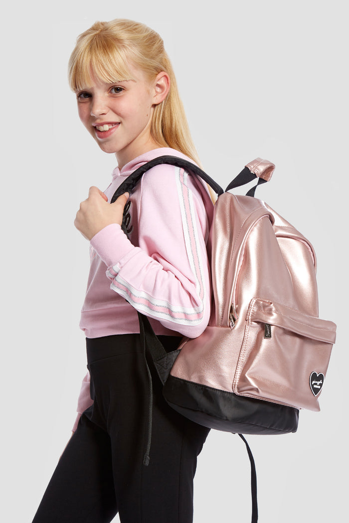 Girl carrying Pineapple Dance Pink Heart Badge Backpack