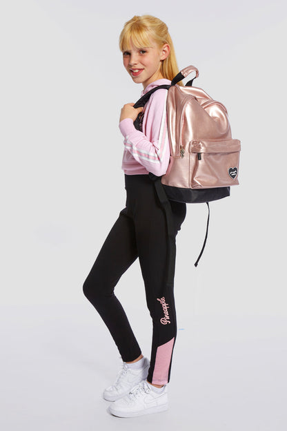 Girl carrying pink Dance Heart Badge Backpack