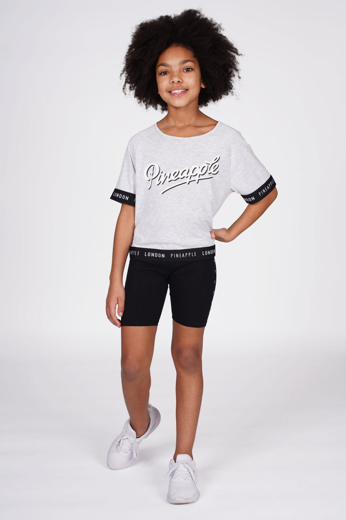 Girl wearing Heart Stud Black Cycling Shorts with grey jacquard t-shirt