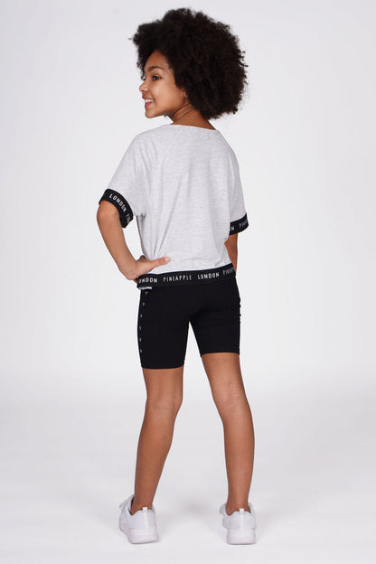 Girl wearing Heart Stud Black Cycling Shorts and grey jacquard t-shirt with contrast hem