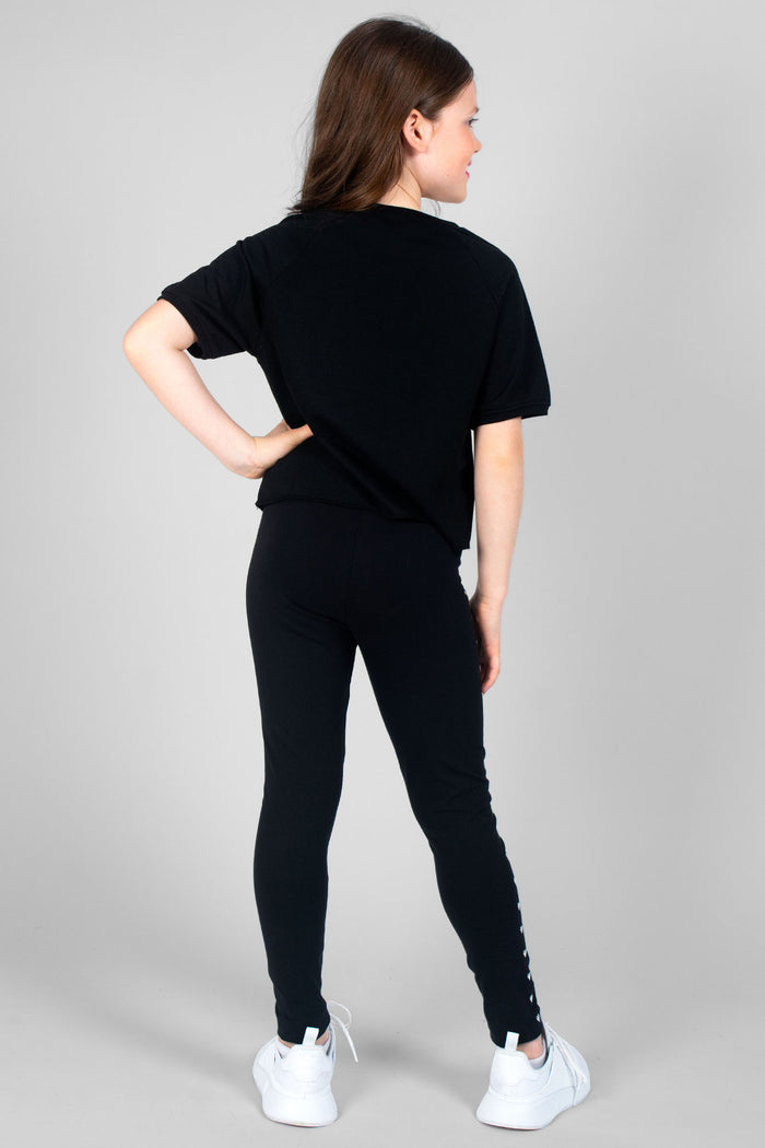 Girl wearing black Heart Stud Leggings and black T-Shirt