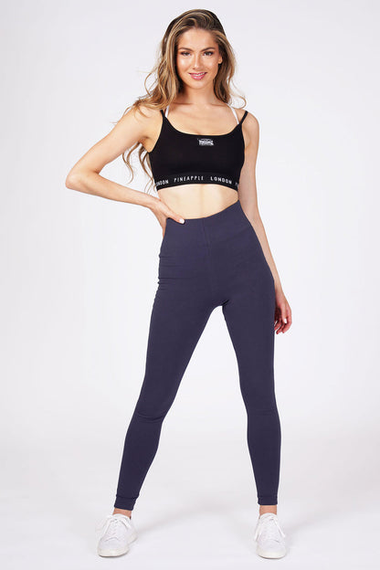 Woman wearingNavy High Waist Leggings and black bra top